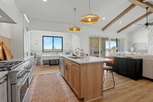 View overlooking island with full sink, breakfast nook, and living area