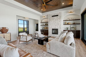 Living area with gas fireplace and eight foot steel door in the entryway