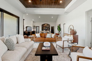 Living area with wood panel ceiling overlooking the primary dining area