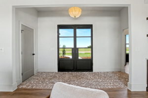 Eight foot steel door in the entryway with windows