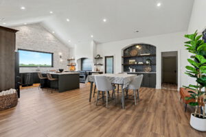 Primary dining area with built-in shelving with beautiful backsplash 