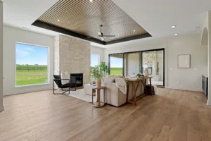 Living area with wood panel ceiling, gas fireplace, and sliding glass doors to outdoor patio