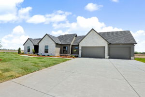 View of the dual garage with paved driveway