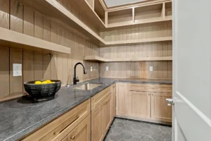 Butler's pantry with built-in cabinetry and shelving
