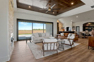 Living area with panoramic sliding glass doors to the backyard