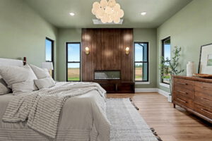 Master bedroom with gas fireplace and full vertical windows