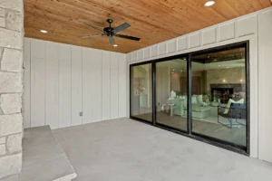 Patio with ceiling fan and view of living area