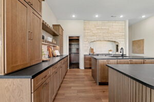 Kitchen with dual islands, built-in cabinetry, and ample counter space 